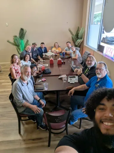 Brand Hyve team and local business owners gathered around a table